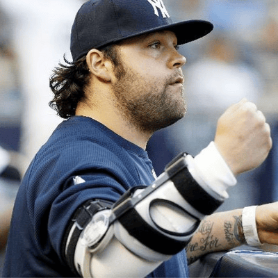 Baseball player wearing an elbow brace at a baseball game