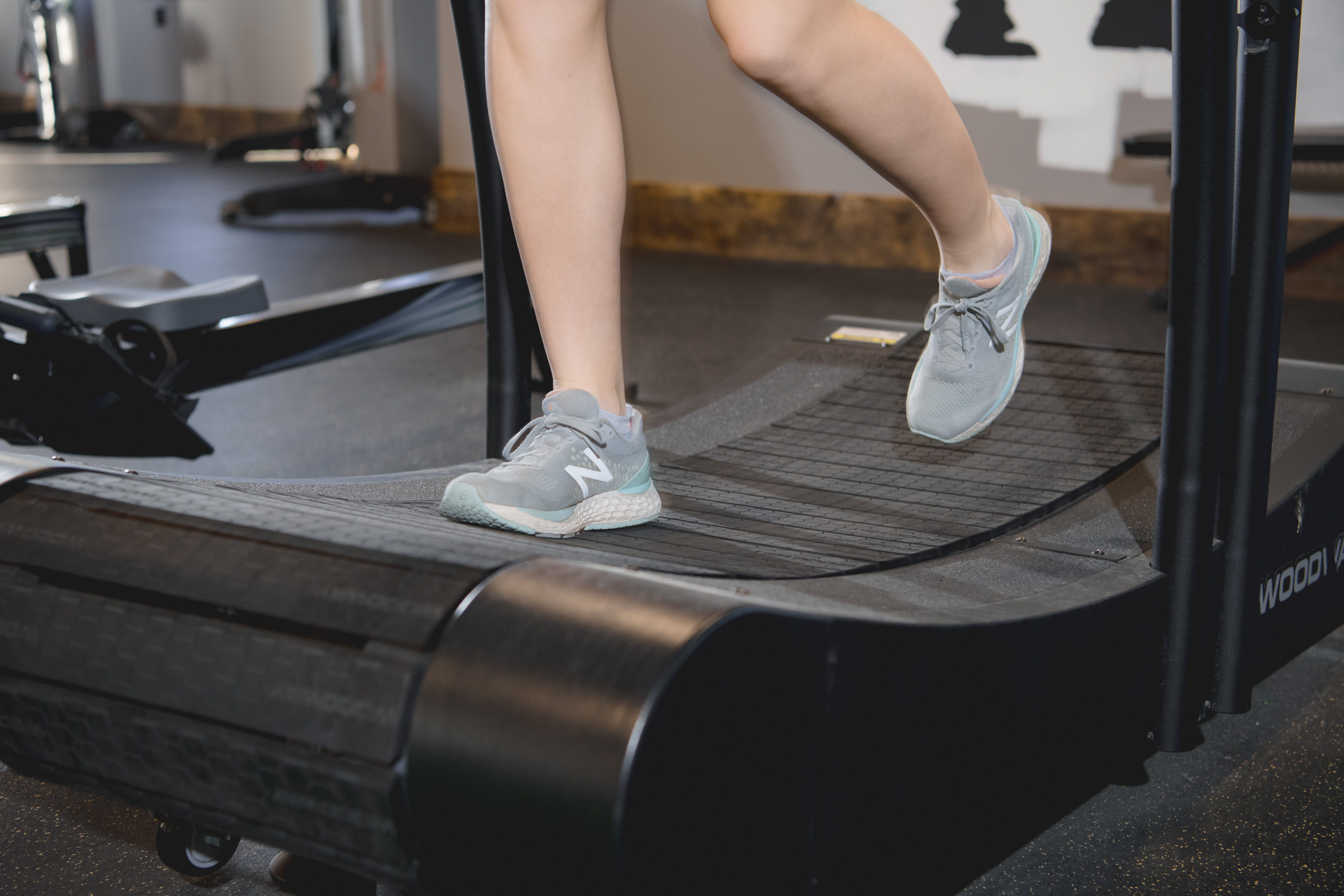 Athlete running on a treadmill during athletic physical therapy.